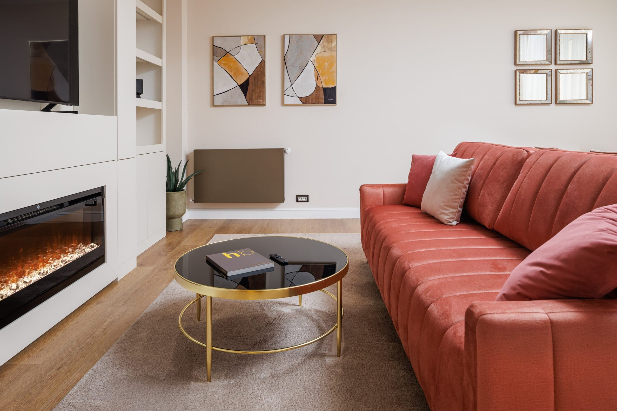 Modern living room with fireplace and red sofa
